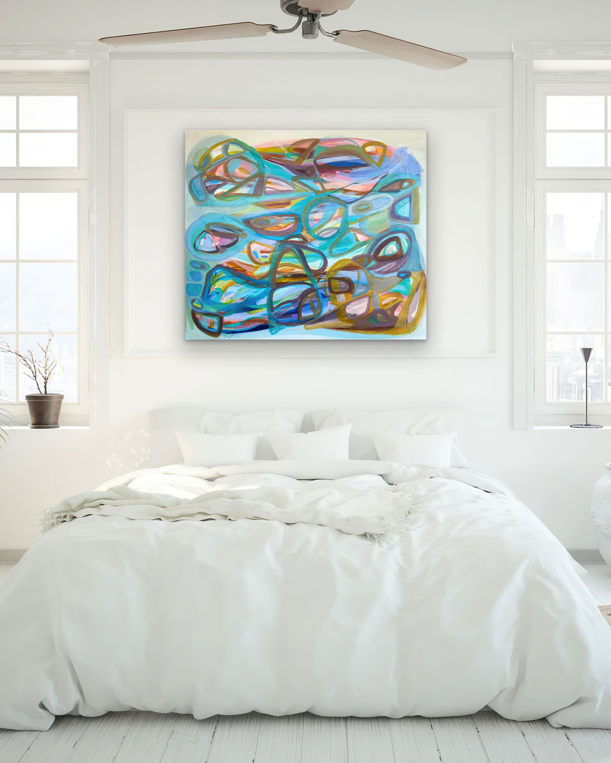 Gabriela-Tolomei-Paintings-Buceo-Espacial-Abstract artwork, colorful abstract painting on a white wall above a bed in a bright room.