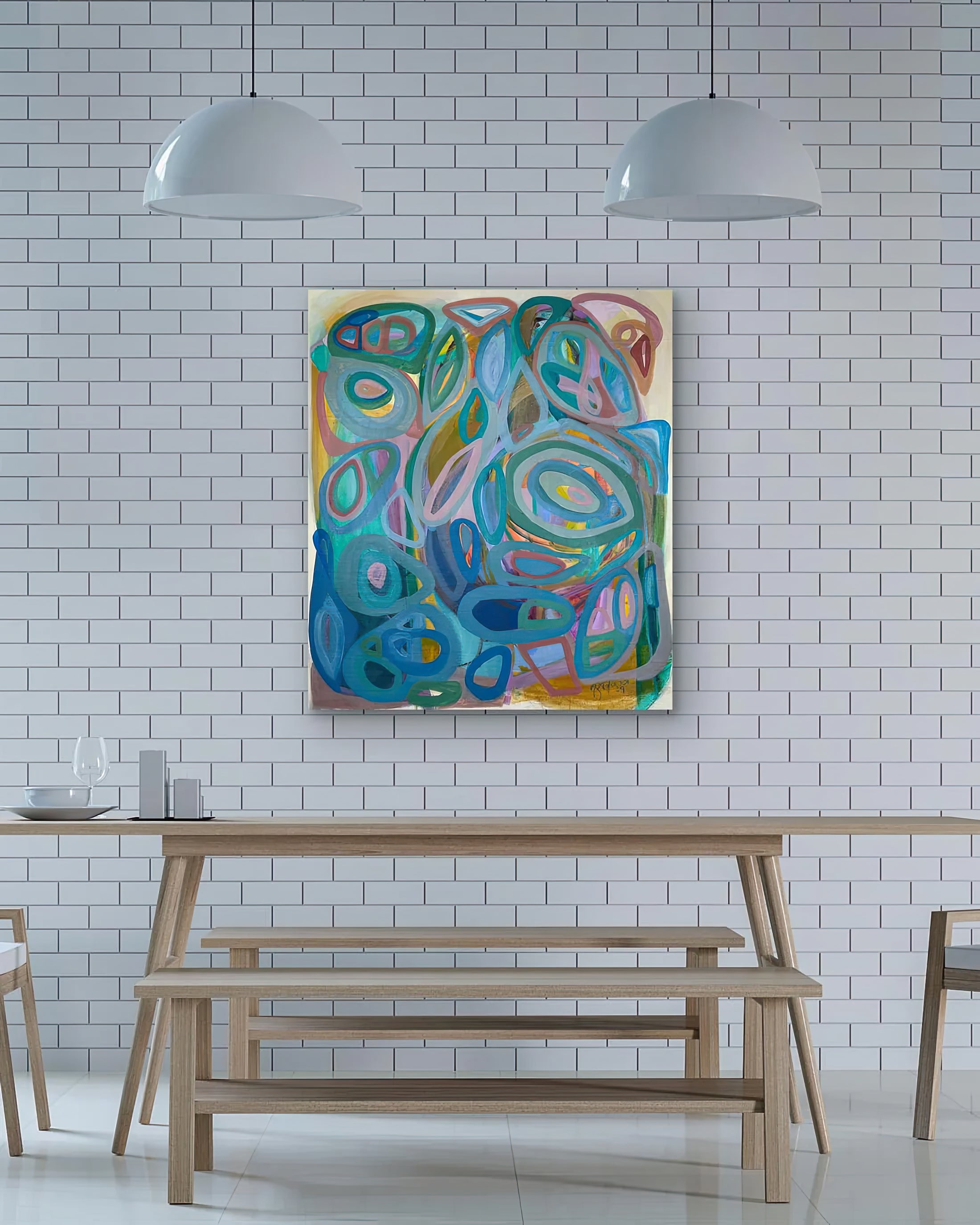 Colorful abstract painting on a white brick wall above a wooden dining table Gabriela-Tolomei-Paintings-Serendipity